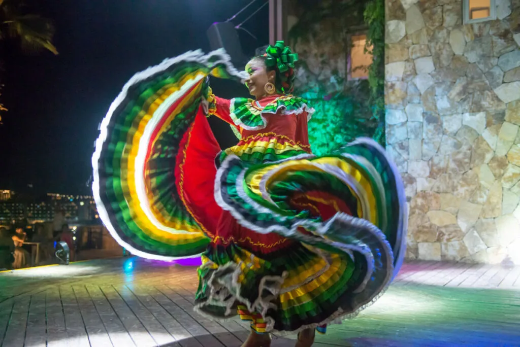 Mexican dancers perrforming traditional dance from the state of Jalisco in colorful dresses in a festival, for viewers around the world. sstkMexicanCulture
