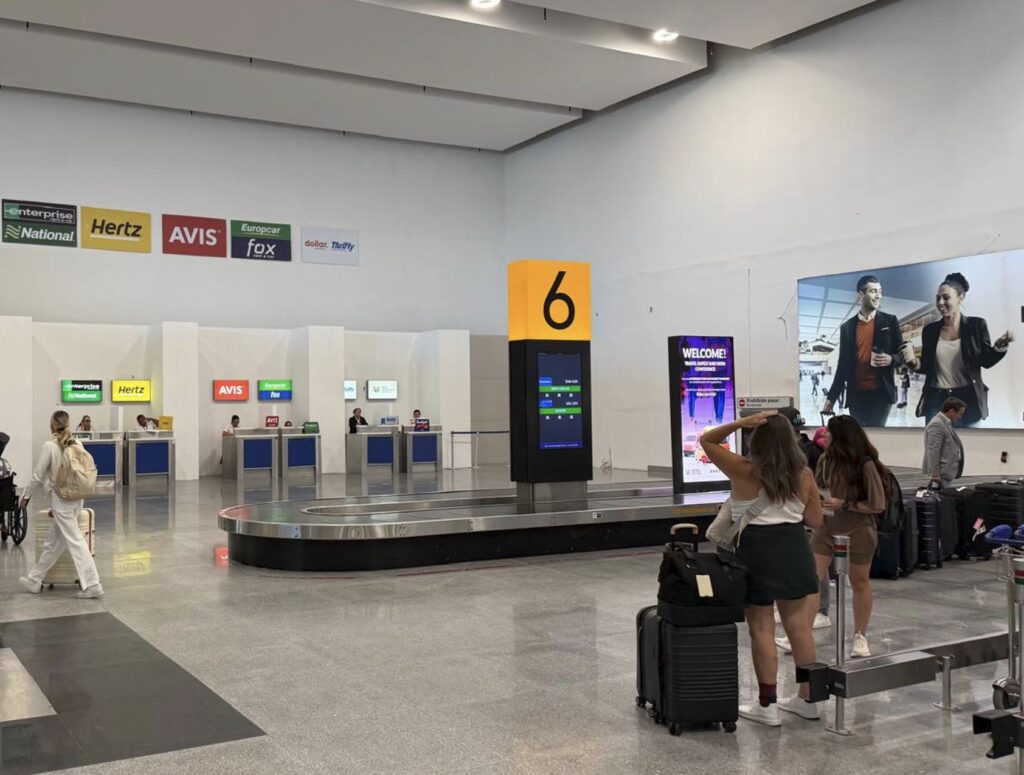 Baggage Lugguge claim airport travelers with suitcase