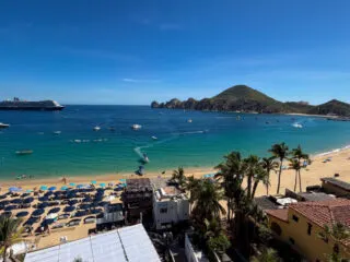 Playa Medano Beach with cruise ship on the left and the arch on the right taken from balcony overlooking beach