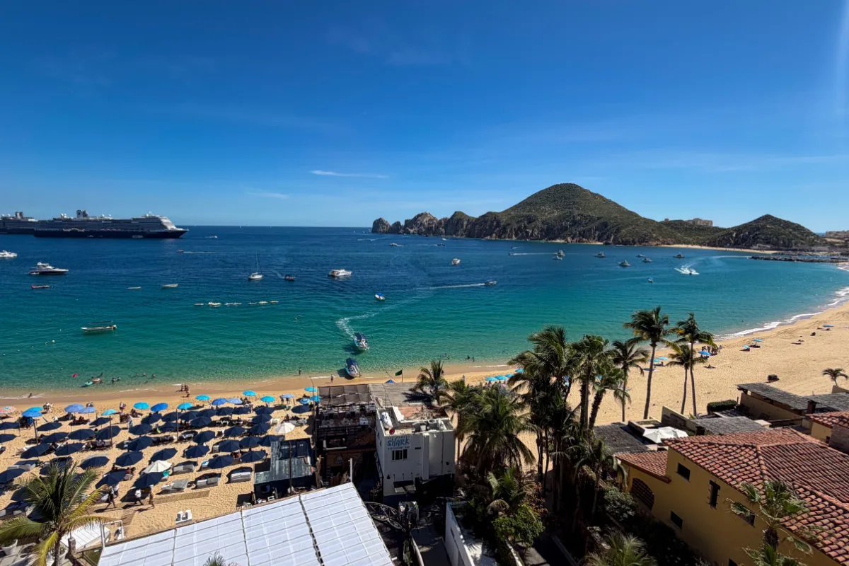 Playa Medano Beach with cruise ship on the left and the arch on the right taken from balcony overlooking beach