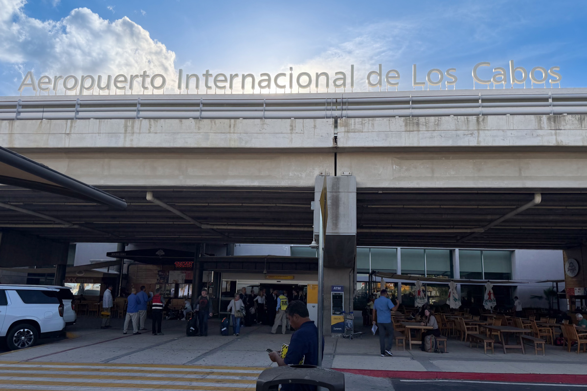 Los Cabos International Airport Arrivals area with tourists finding transportation