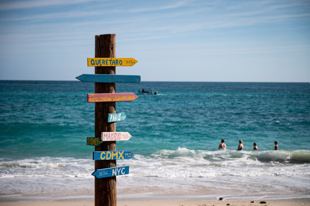 A variety of mostly tongue-in-cheek directional signs next to the beach at Cabo Pulmo, a protected National Marine Park recognized as a World Heritage Site by UNESCO.
